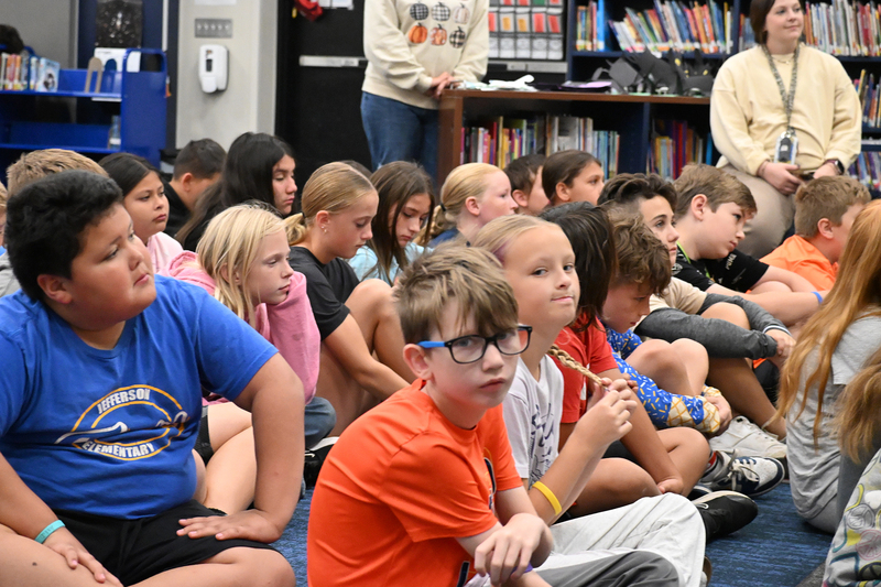 group of 5th graders listen to presentation