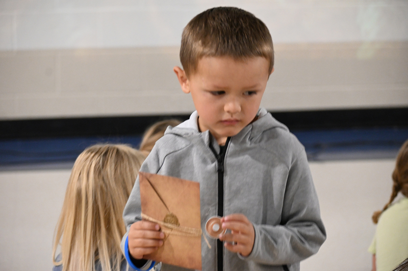 little boy holding book