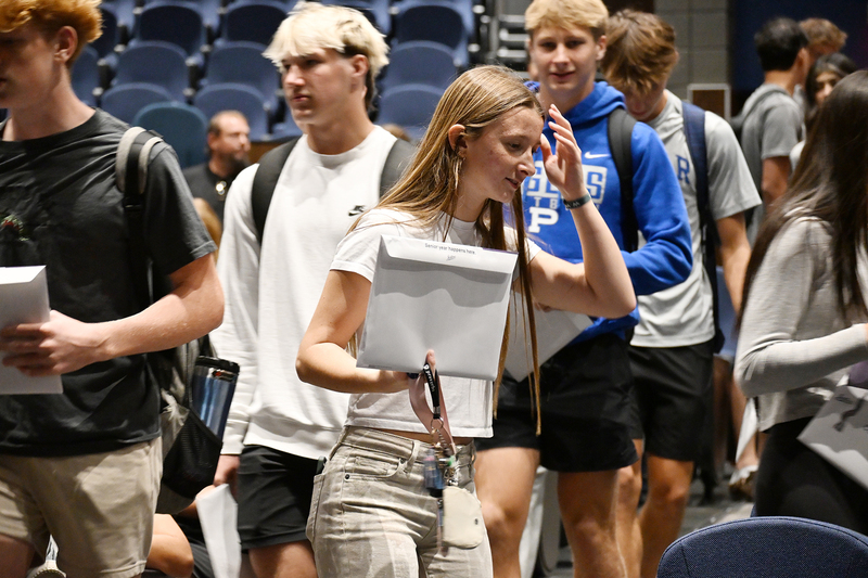 girl walking with senior envelope