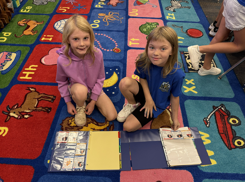 girls on carpet with cards