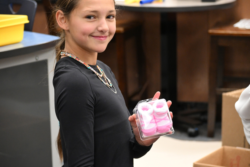 girl holding baby socks