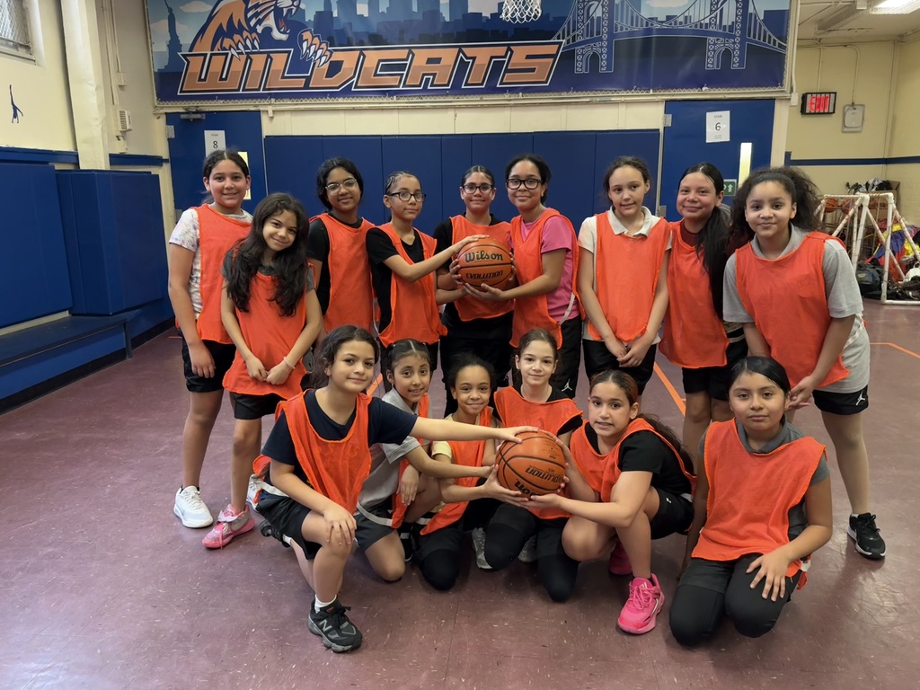 PS 115 girls basketball team posing at the end of their successful season
