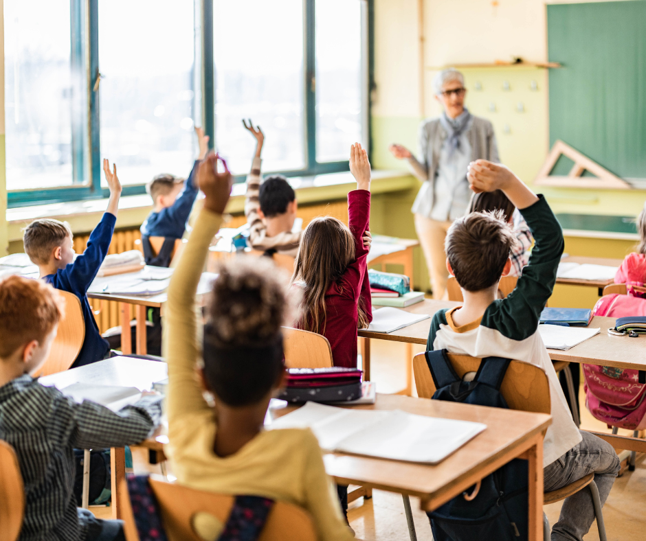 hands raised in classroom