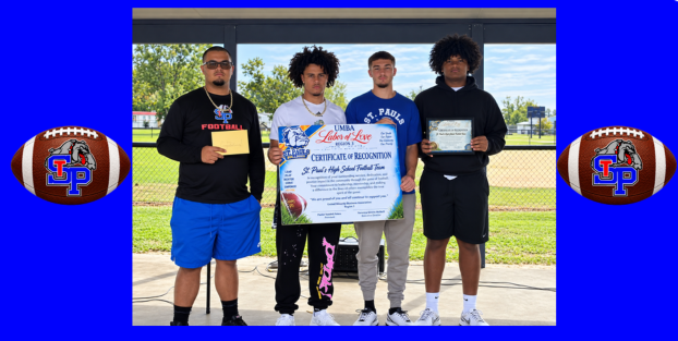 SPHS football players holding a sign recognizing a good season