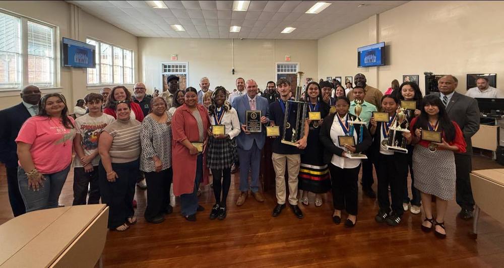 PSRC Board members and ECHS staff and students stand during board meeting honor