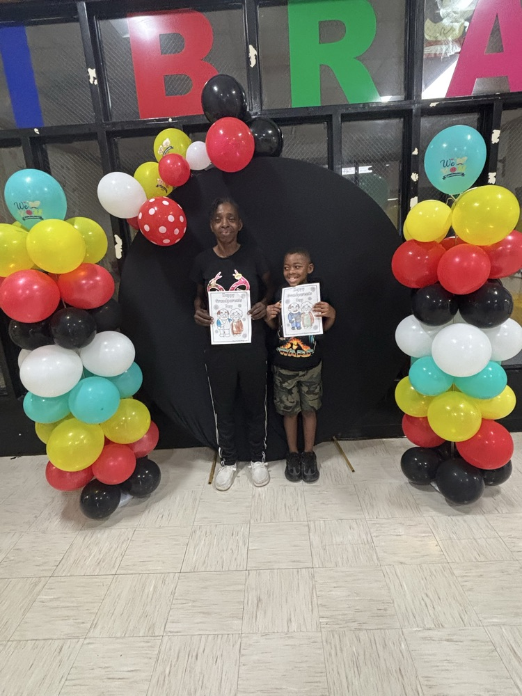Family posing in front of colorful balloons
