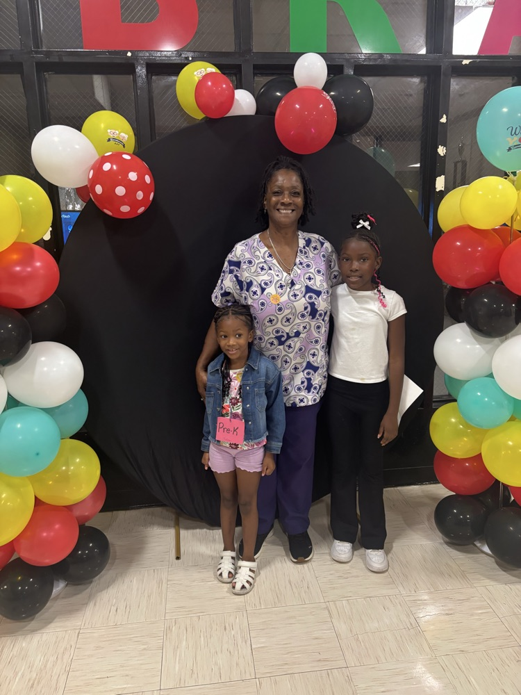 Family posing in front of colorful balloons