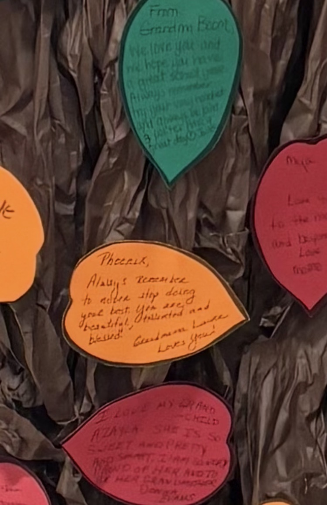 Closeup of a grandparent’s message on a colorful paper leaf