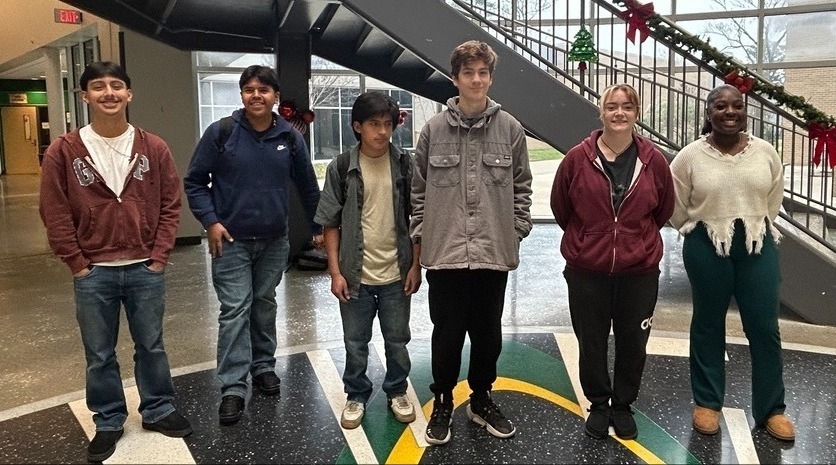 Student artists standing in Mills University Studies High School