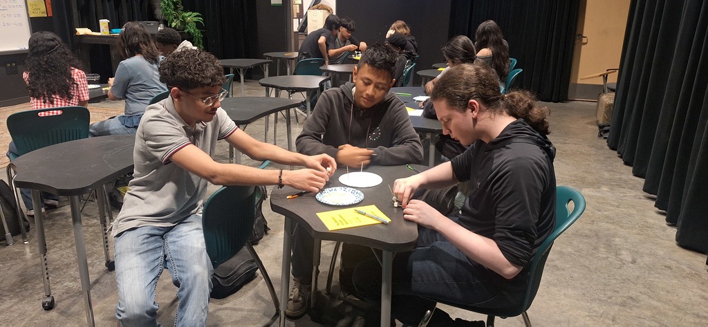 Students working in groups on building