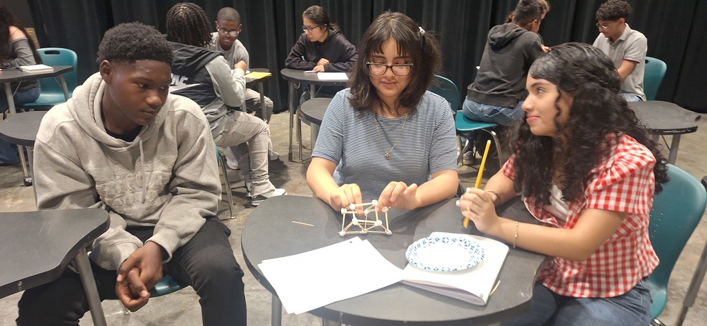 Students working to building structures