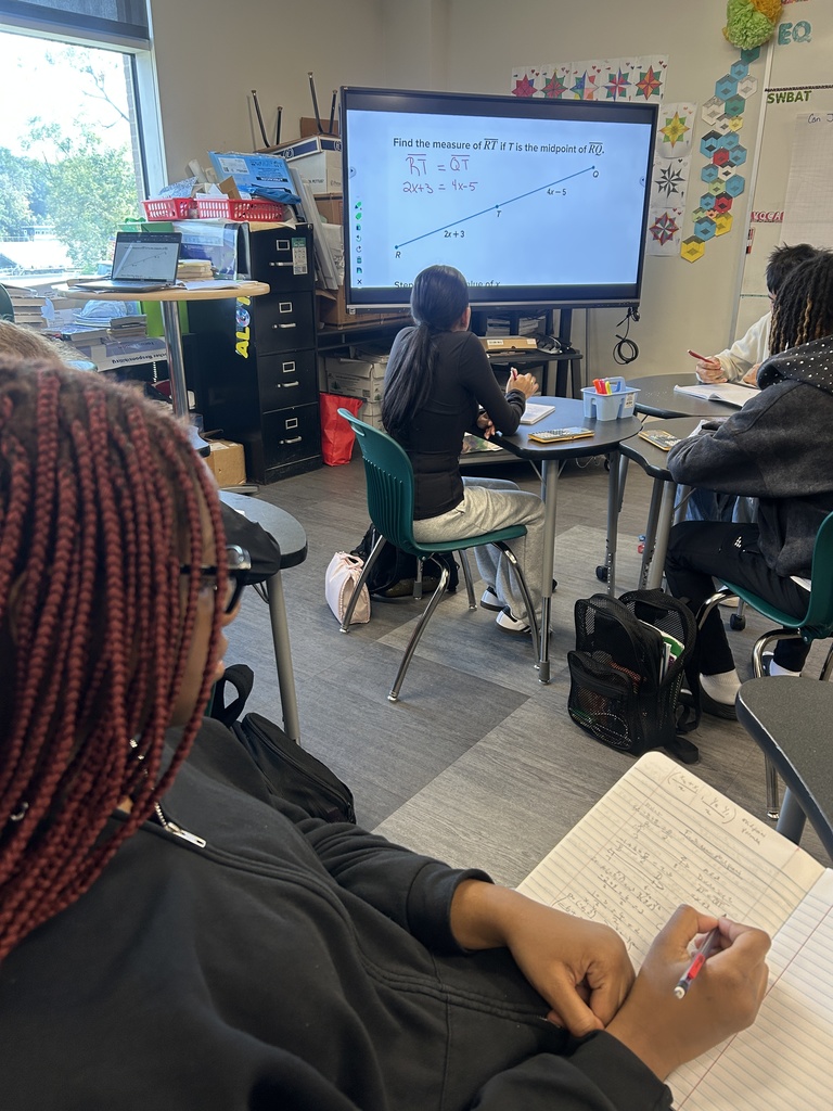 Students working on geometry in journal