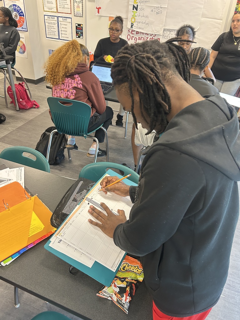 Student writing in planner