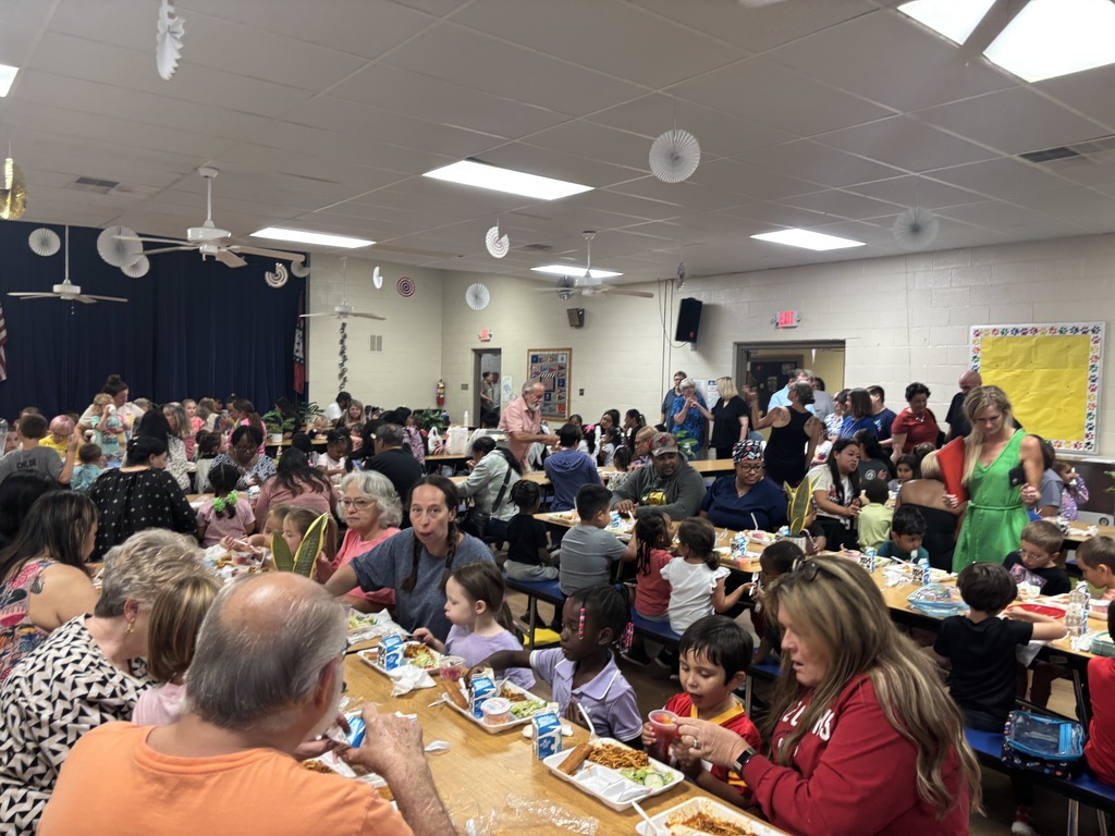 Image of students and their grandparents enjoying lunch together