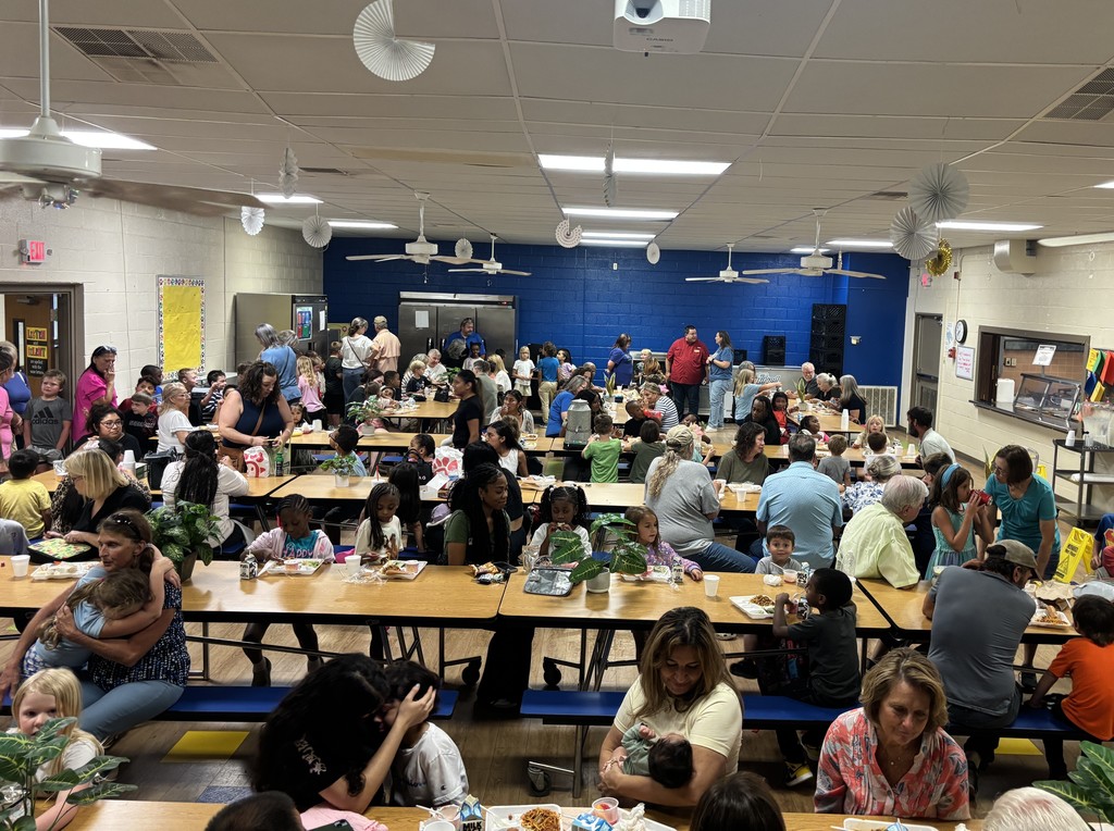 Image of students and their grandparents enjoying lunch together