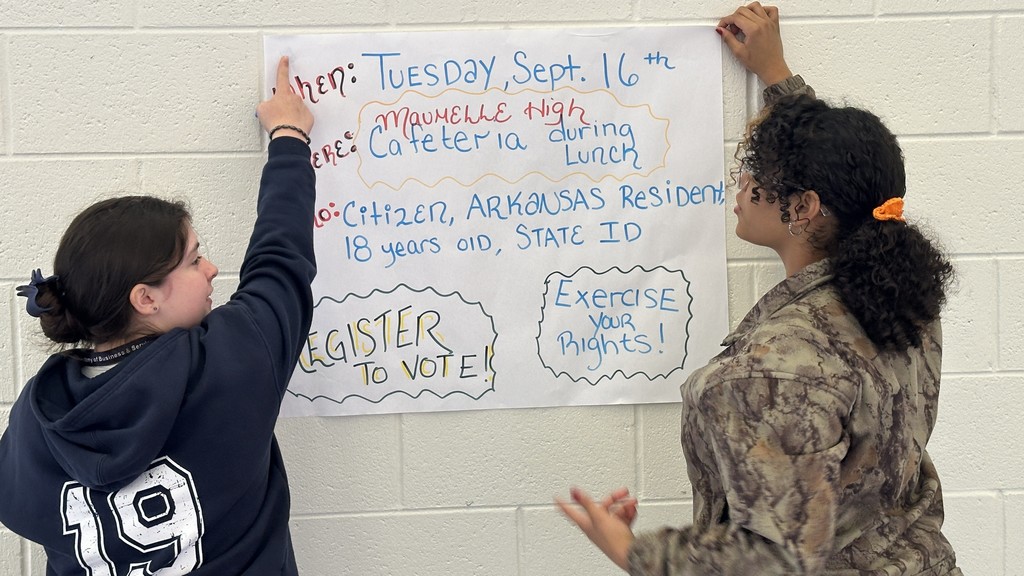 Maumelle High School students hang up National Voter Registration Day poster