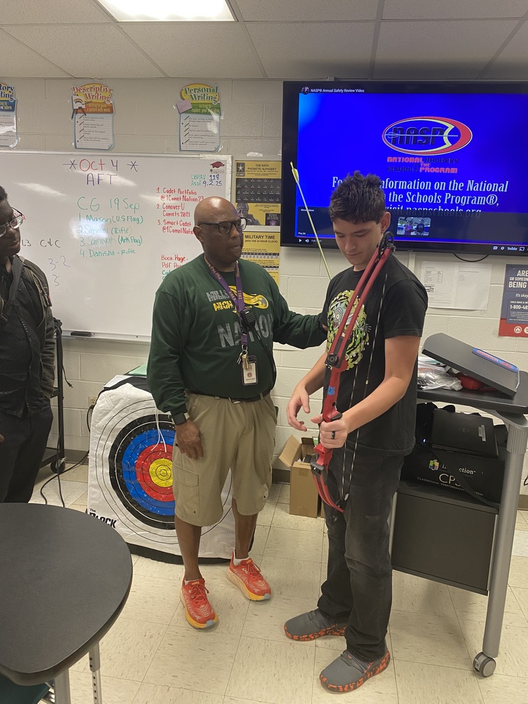 Instructor helping student with bow