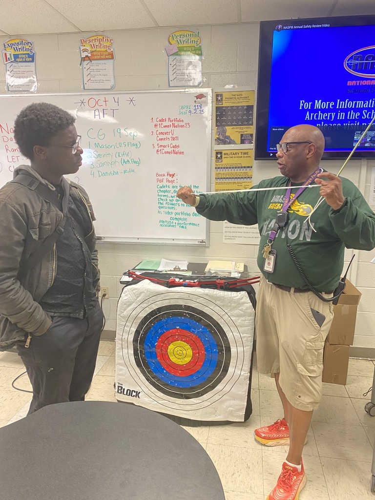 Instructor demonstrating appropriate use of bow and arrow
