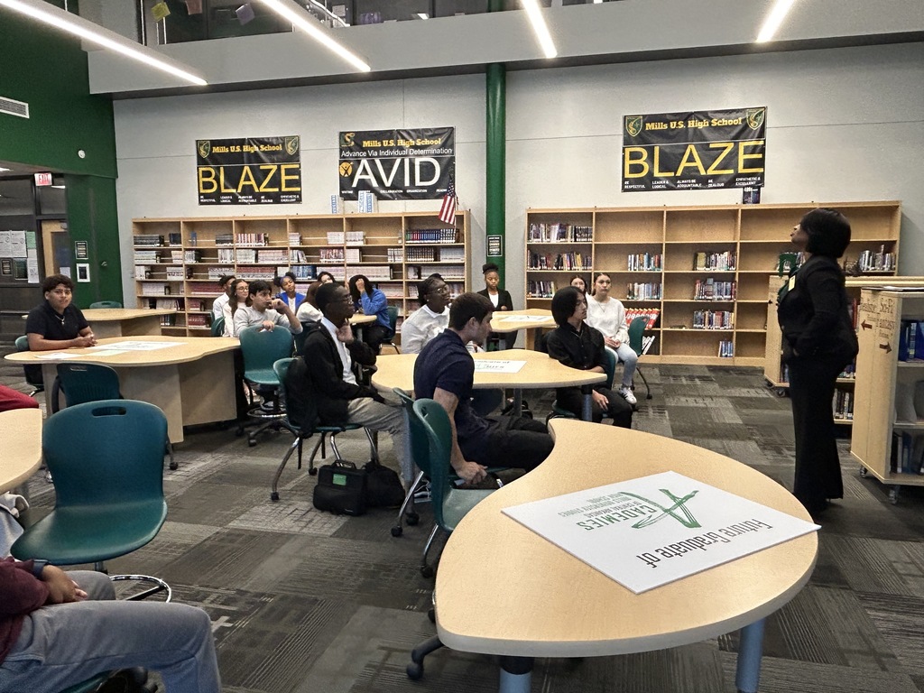 Students at tables listening to guest speaker