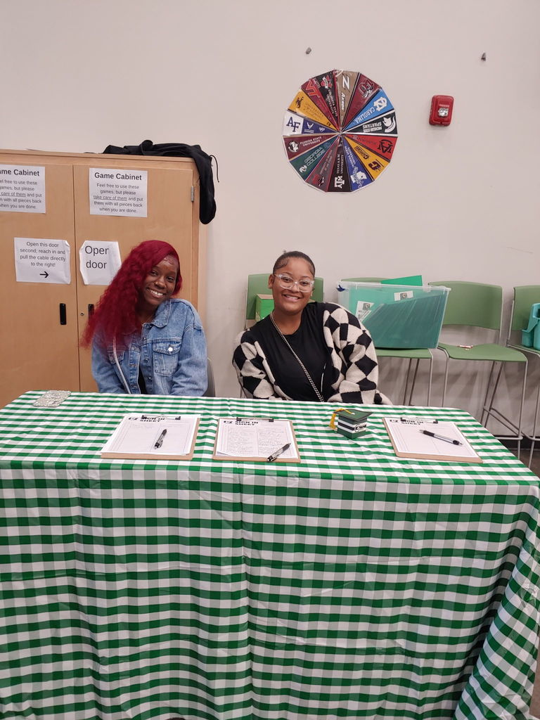 Students sitting at sign-in table