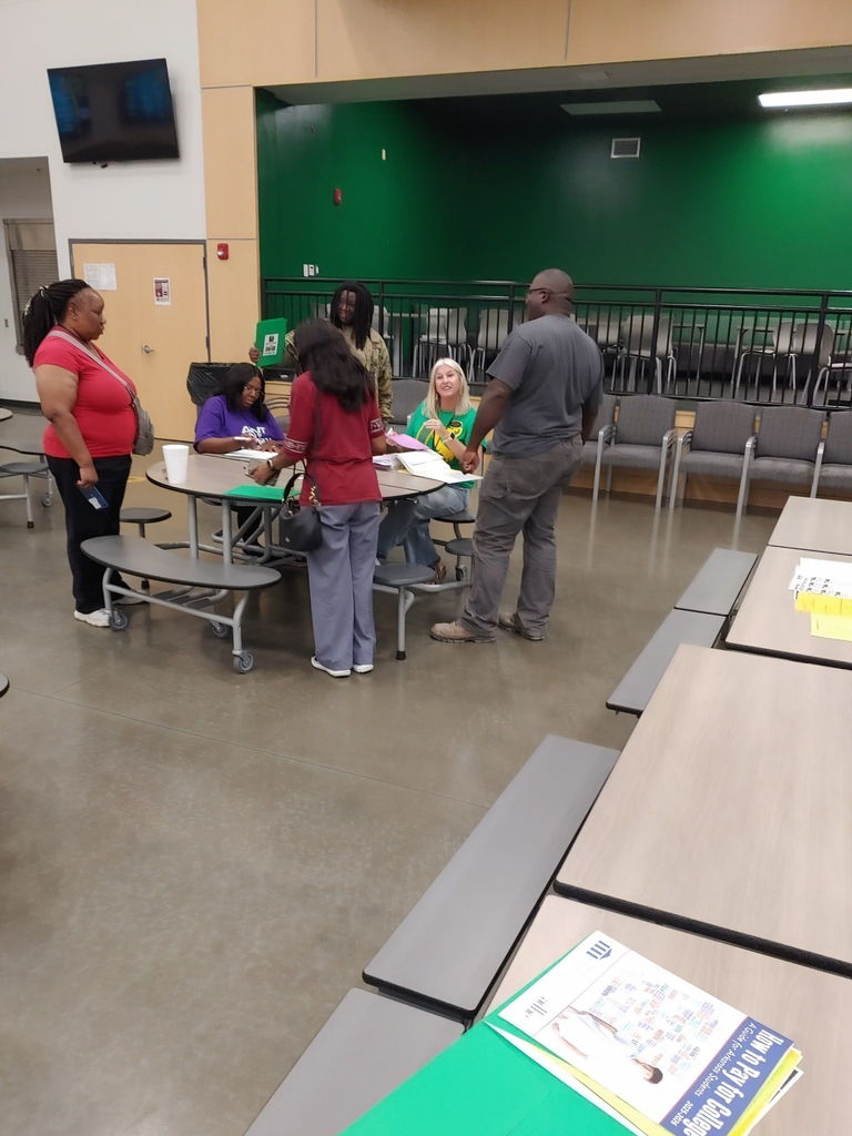 Parents speaking to two school counselors at round table
