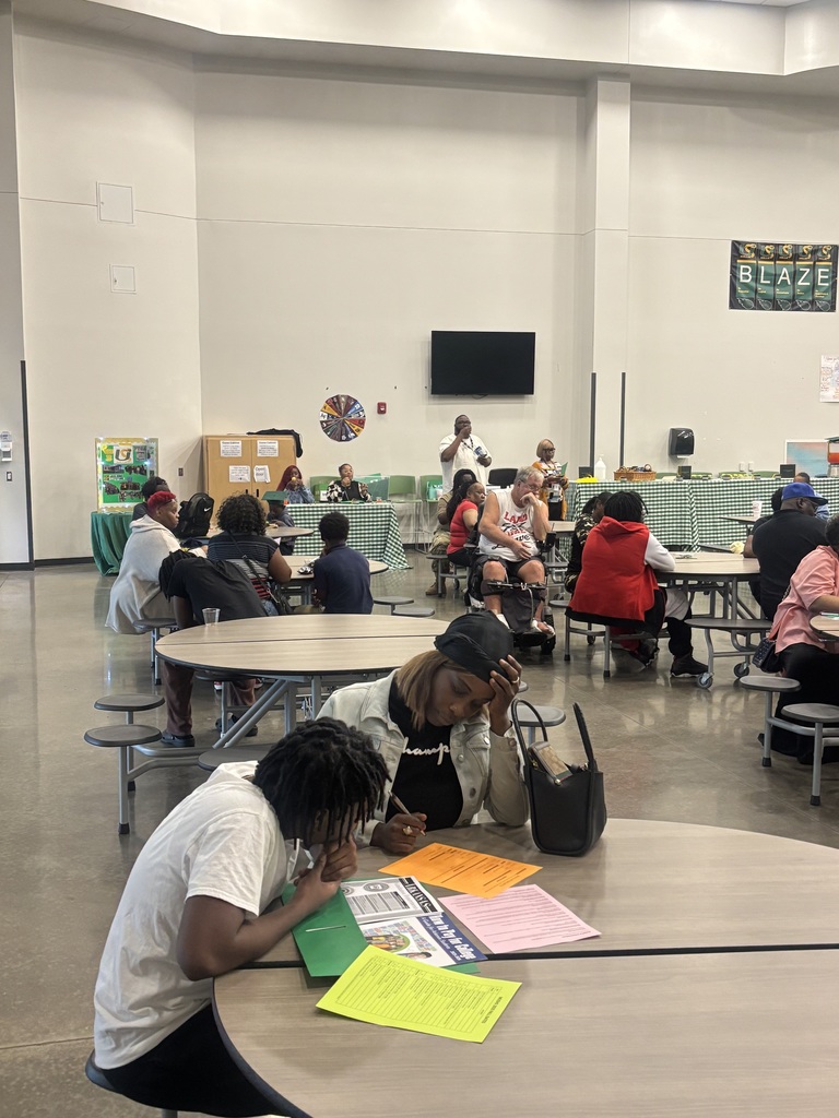 Parents and students in cafeteria for meeting