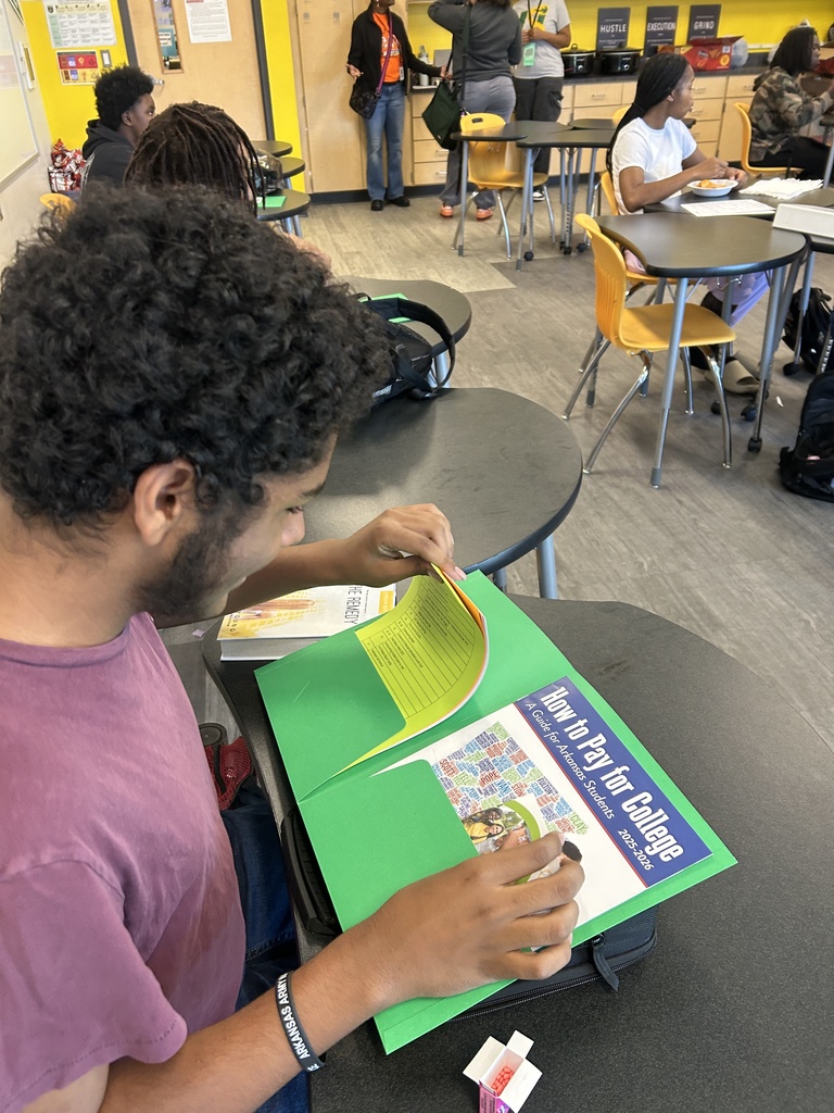 Student looking at handouts on senior materials
