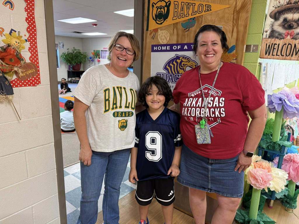 Group of students wearing college shirts for AVID Day Sherwood Elementary