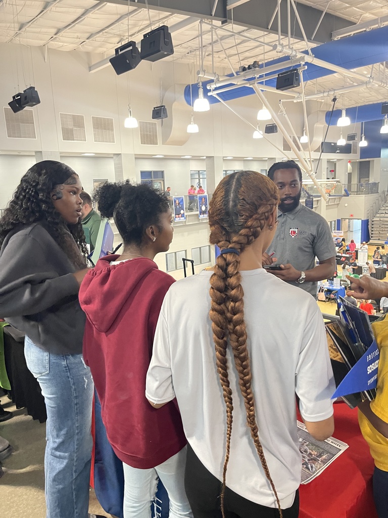 Students speaking to college recruiter