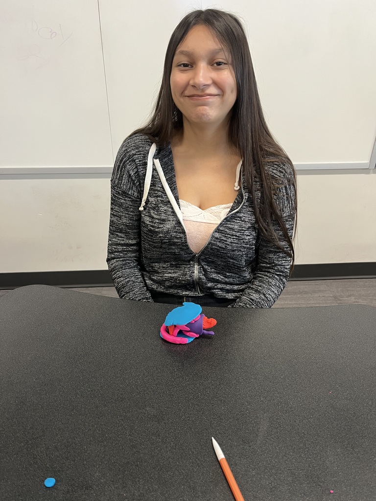 Student with her model brain made of clay