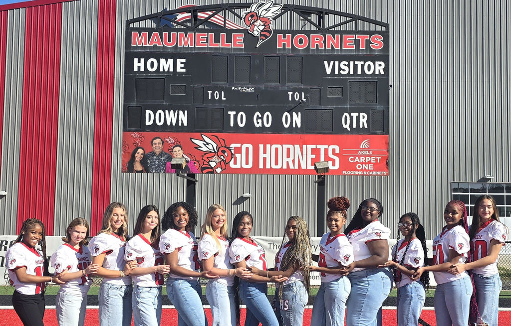 Maumelle High School Homecoming Court standing under the scoreborard.
