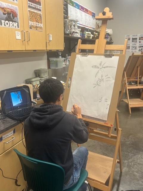 Student drawing palm trees