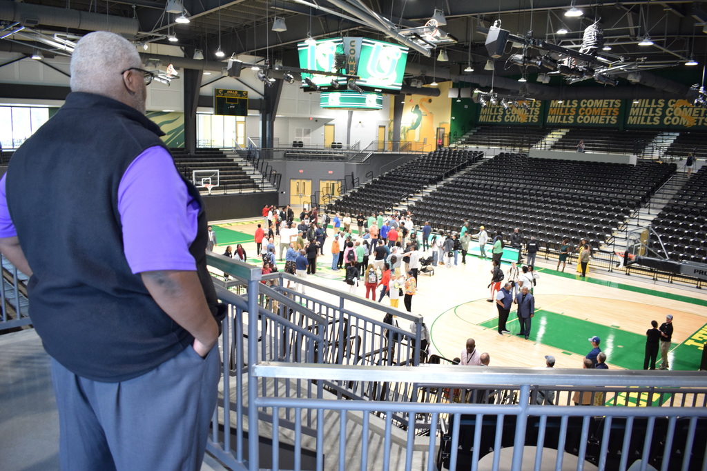 Interior of the Raymond A. Cooper Arena . A crowd on the basketball court.