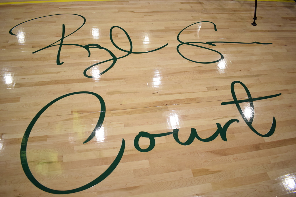 A signature on a basketball court saying "Ray Cooper Court"
