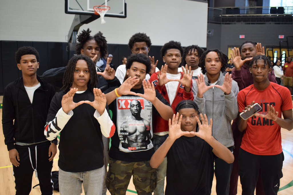A group photo of the Mills University Studies High School basketball team