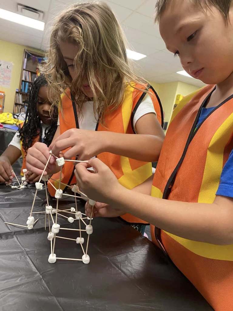 Daisy Bates students pretend to be construction workers on AVID ROCK YOUR SCHOOL DAY building a marshmallow and toothpick tower