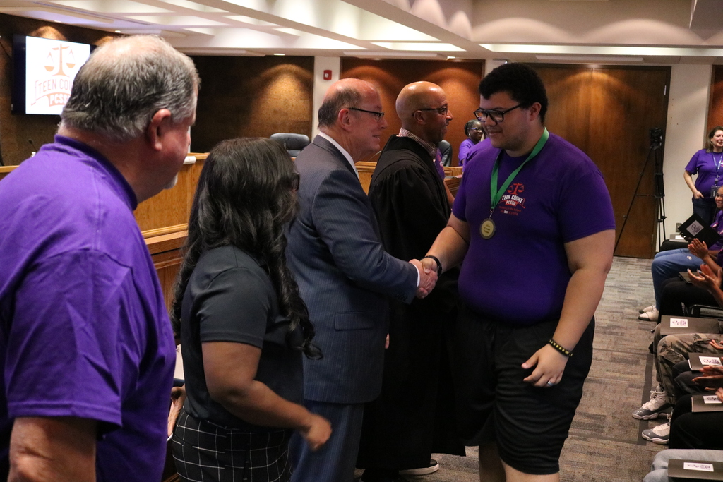 Mills University Studies High School student shaking Judge Barry Hyde's hand during PCSSD Teen Court swearing in.