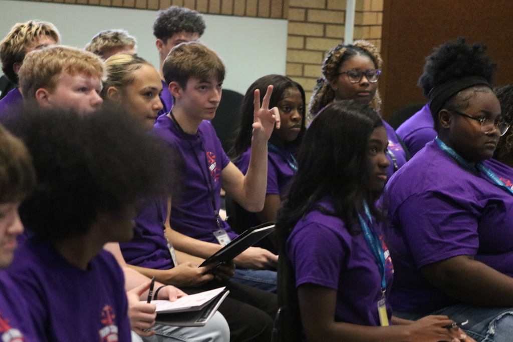 Maumelle High School student raising his hand in a crowd of PCSSD Teen Court students