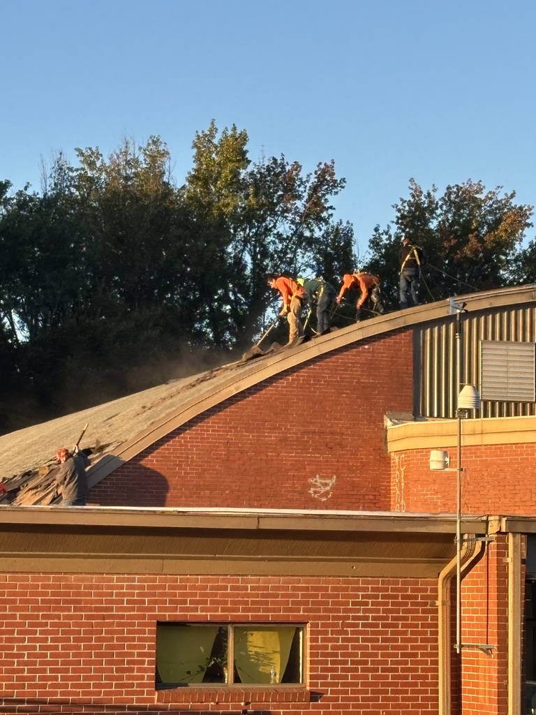 Workers work on our new roof for the gym!