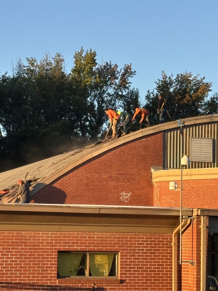 Workers work on our new roof for the gym!