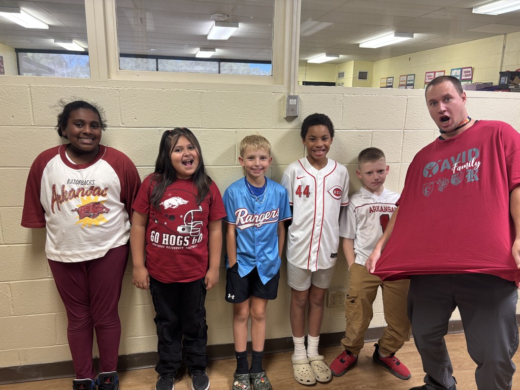 Fifth Graders & their teacher in college shirts/jerseys to show that we are educating ourselves on a drug free lifestyle.