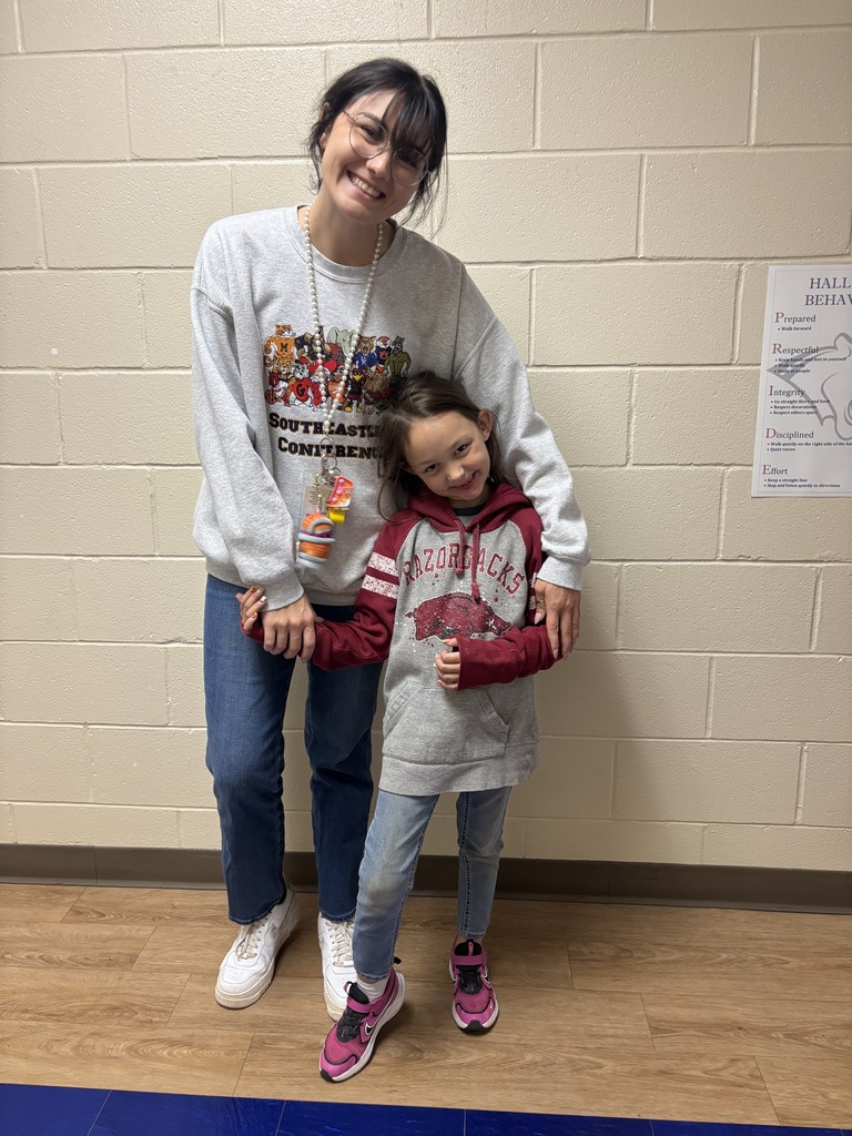 First Grader and School Counselor in college shirts/jerseys to show that we are educating ourselves on a drug free lifestyle.