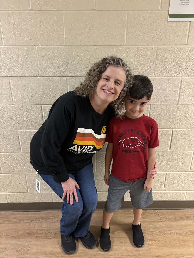 First Grade Student and Music Teacher in college shirts/jerseys to show that we are educating ourselves on a drug free lifestyle.