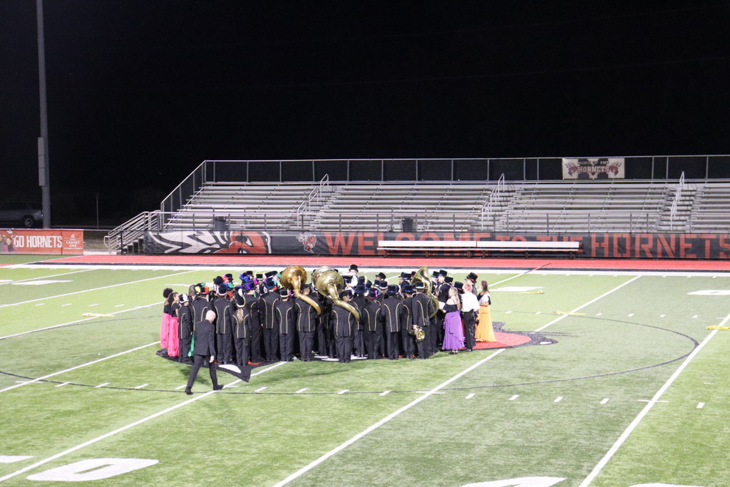 Joe T. Robinson Band huddled on the field