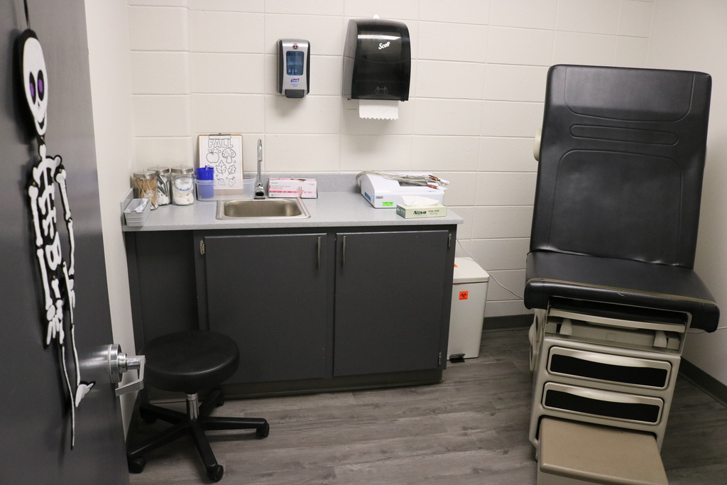 A healthcare worker administering a vaccine to a patient in a medical office.
