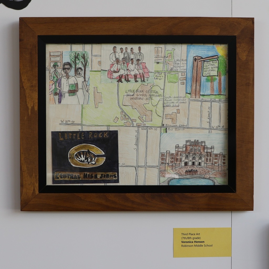 Framed artwork depicting a map of a location with buildings, people, and signage for "Little Rock Regional Airport" and "Cleveland Bldg".