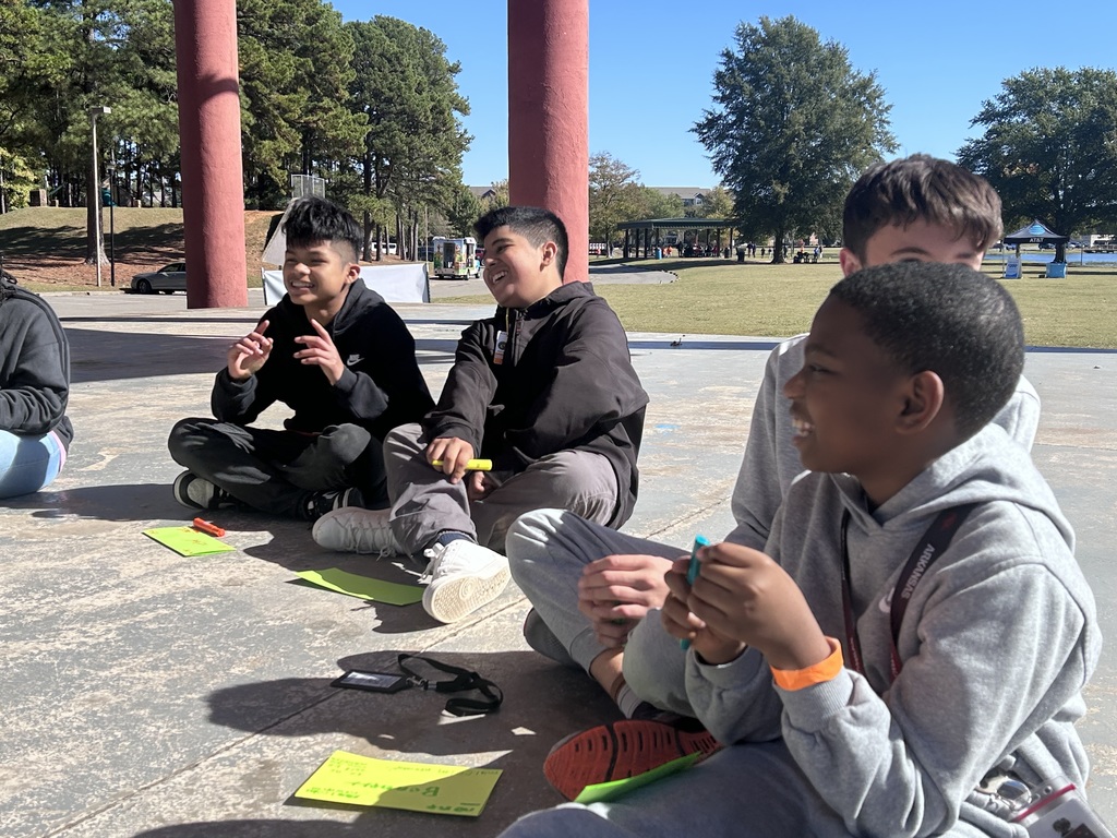 Picture of AVID scholars laughing together in amphitheatre at Lake Willastein Park