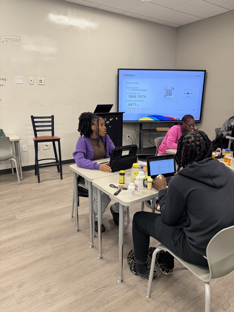 Students in groups working on health lesson analyzing medication