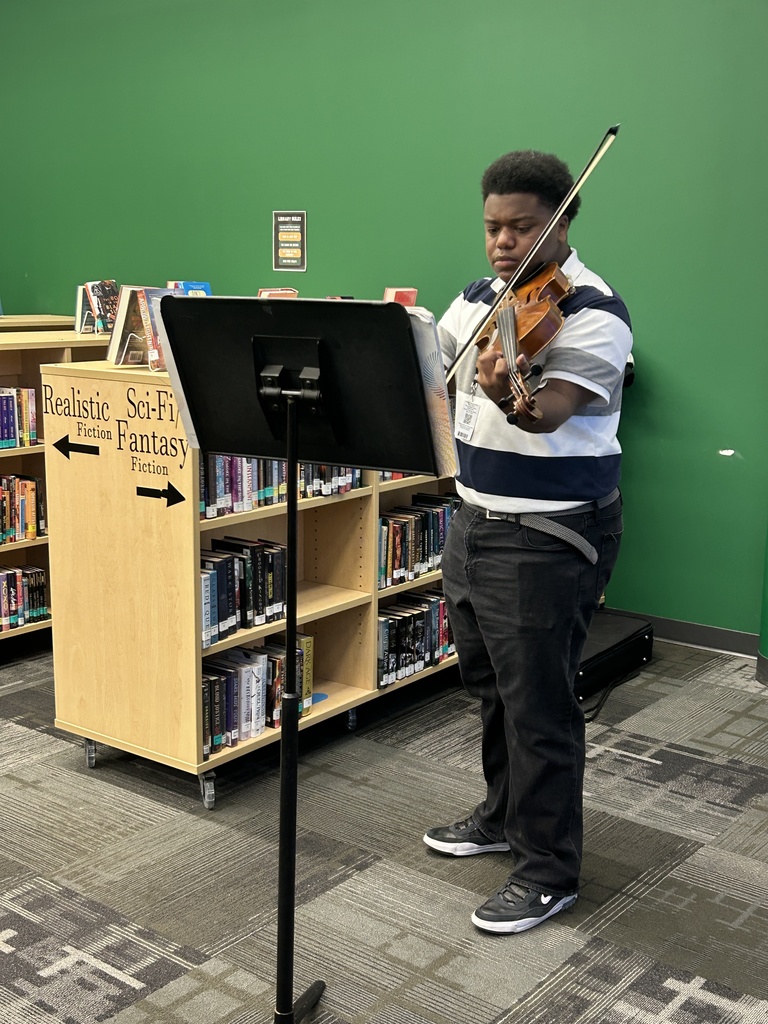 Student playing violin for event