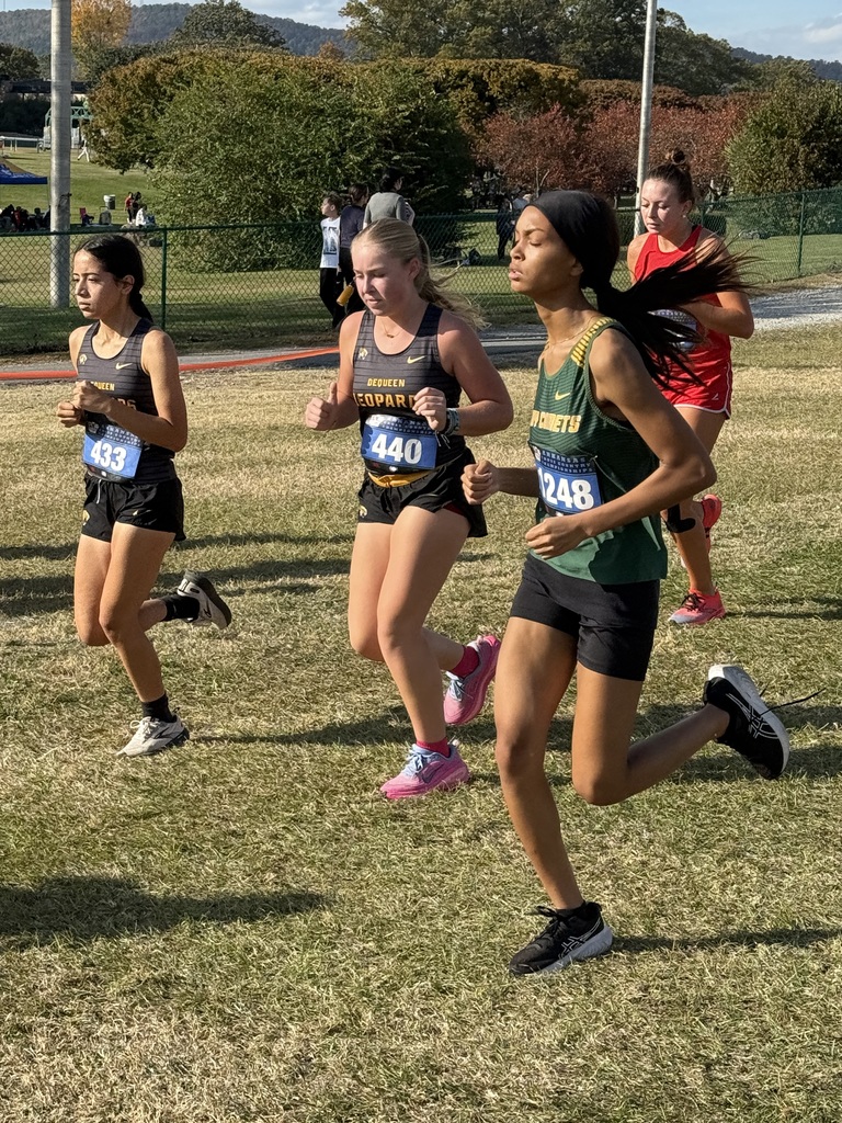 Student running in field with competitors